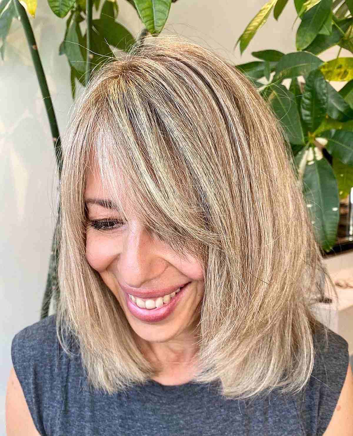 Medium Layered Haircuts with Side-Swept Bangs: Style & Versatility