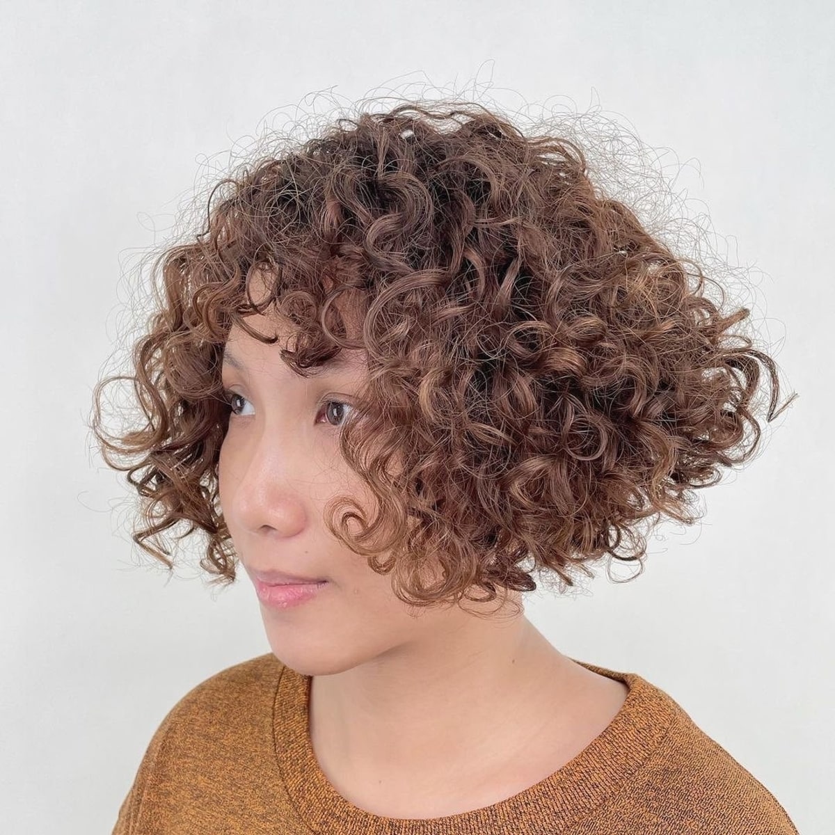 Curly Bob with Bangs: Styles & How to Choose the Best Cut for You